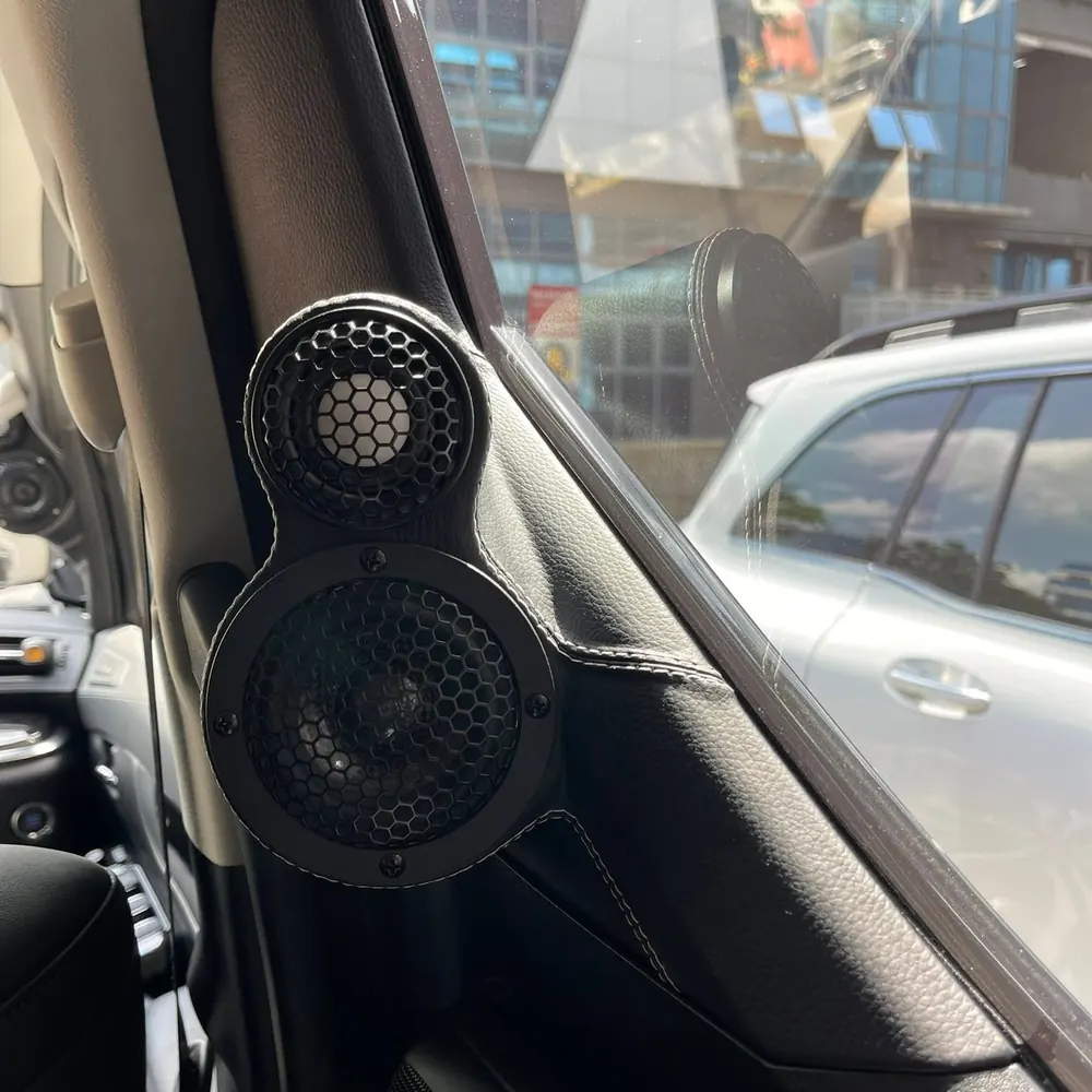 Close-up of custom A-pillar speaker pods with contrast stitching by Ethos Audio